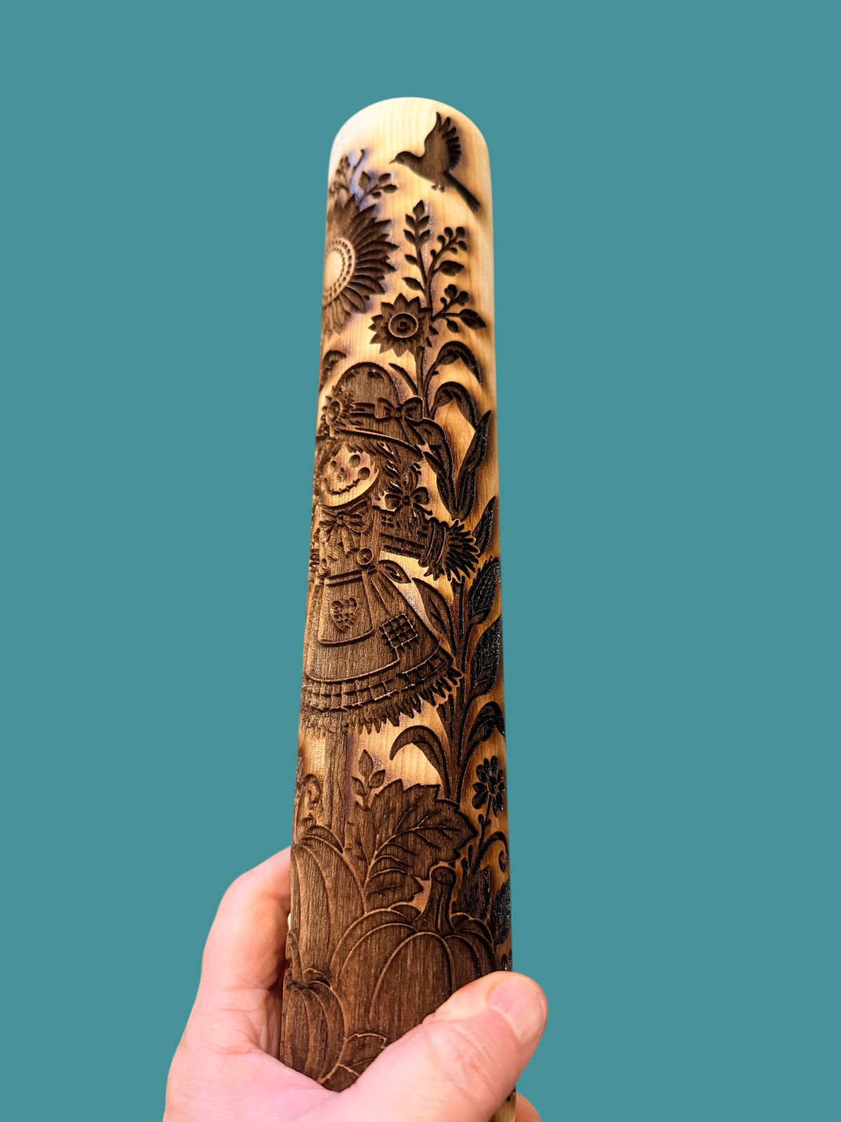 Sharon Hoppe Designs wooden rolling pin with laser-engraved scarecrow, pumpkin, and sunflower fall harvest patterns.