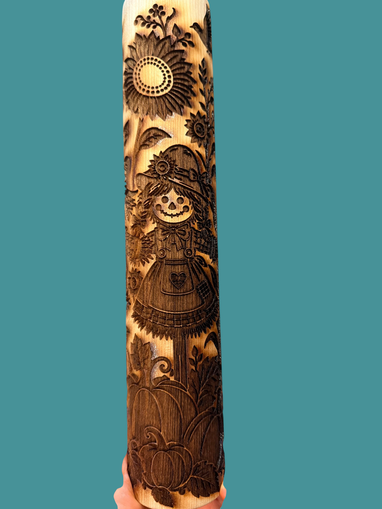 Sharon Hoppe Designs wooden rolling pin with laser-engraved scarecrow, sunflower, and pumpkin fall harvest patterns.