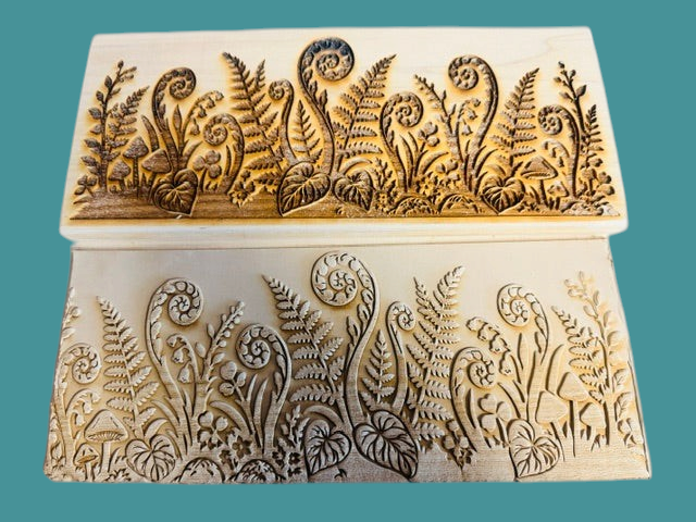 Sharon Hoppe Designs Fiddle Fern Forest wooden muggie boards with intricate laser-engraved botanical fern patterns.