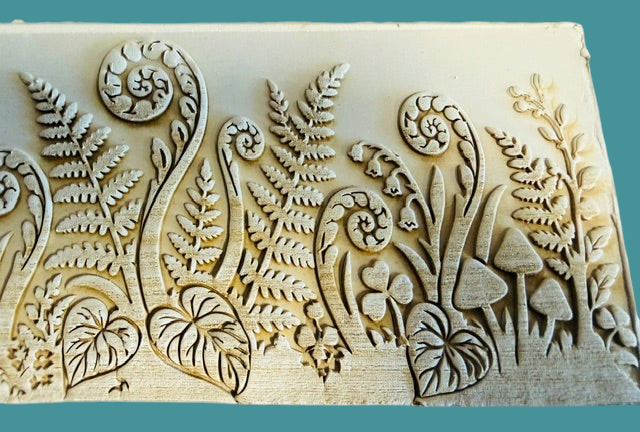 Sharon Hoppe Designs Fiddle Fern Forest Muggie board featuring intricate embossed fern and mushroom botanical motifs.