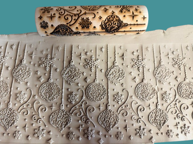 Sharon Hoppe Designs wooden rolling pin with laser-engraved Christmas ornament and snowflake pattern on clay