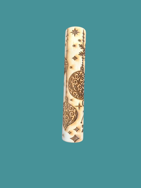 Sharon Hoppe Designs wooden rolling pin with laser-engraved Christmas ornament, snowflake, and star patterns.