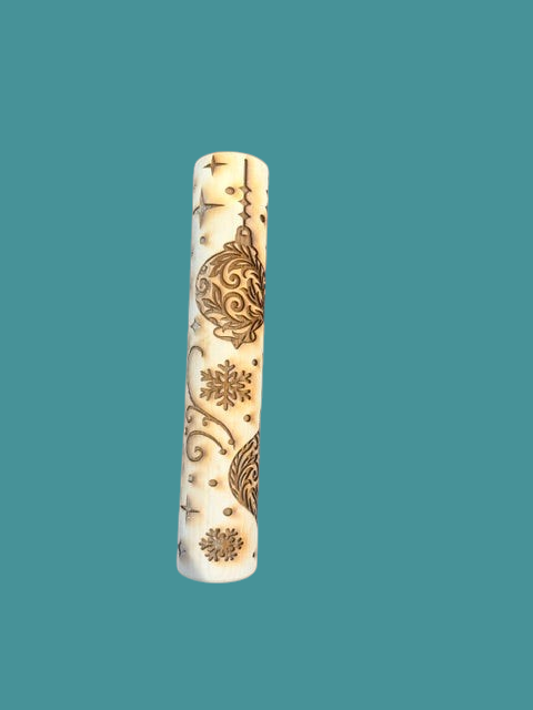 Sharon Hoppe Designs wooden rolling pin with laser-engraved Christmas ornament, snowflake, and star patterns.