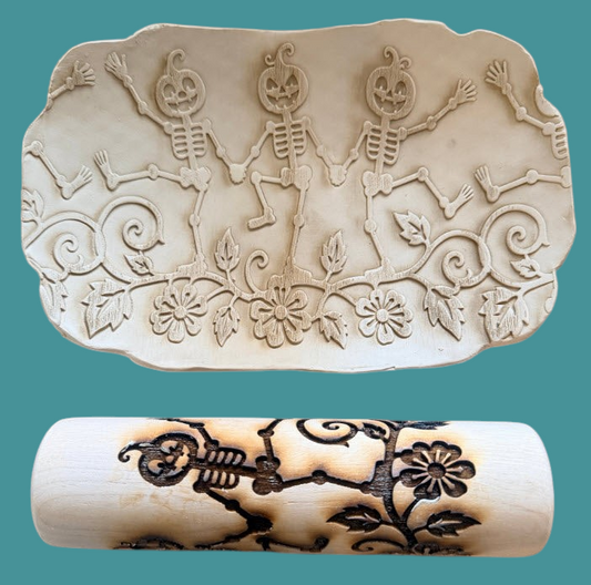 Sharon Hoppe Designs 7-inch wooden rolling pin with dancing skeleton and pumpkin pattern used on clay pottery